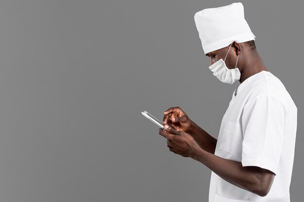 professional young doctor standing sideways copy space