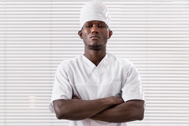 professional young doctor with arms crossed