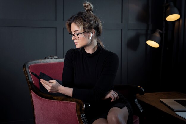 Professional young woman holding mobile phone