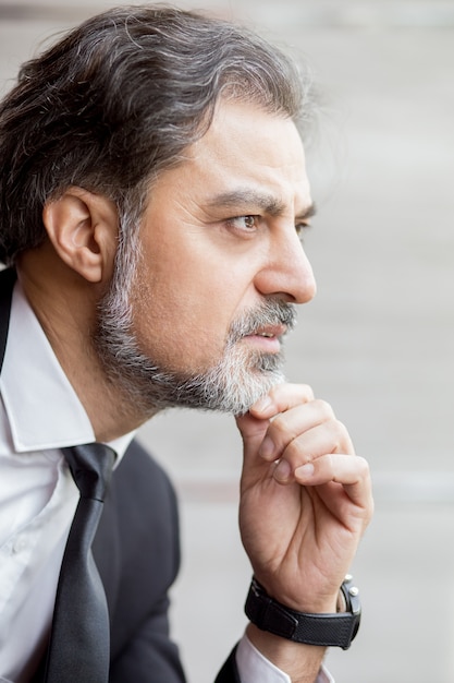 Profile of pensive middle-aged business leader