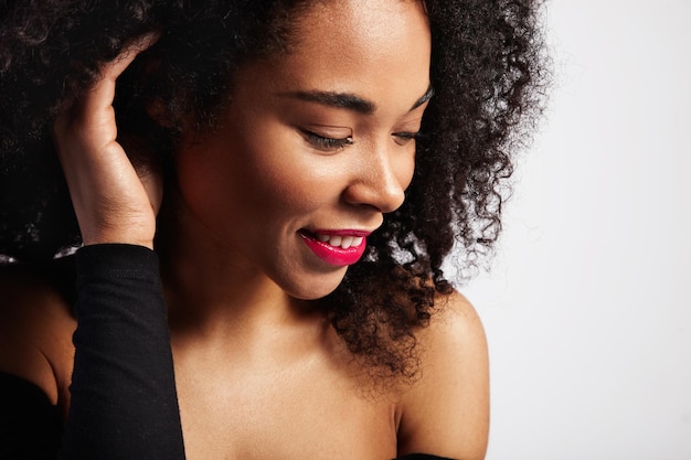 Profile portrait of black woman with curly hair watching aside