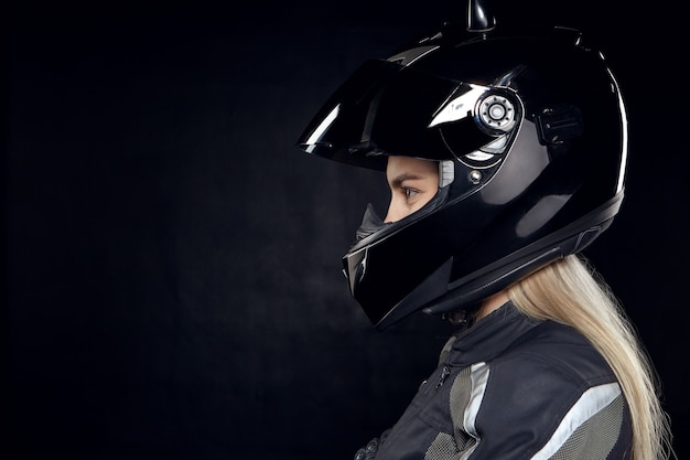 Profile portrait of fashionable young European woman rider with blonde hair