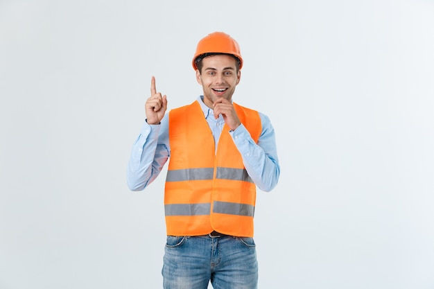 Profile of a woman pointing on copy space for an advertisement isolated on a yellow background.