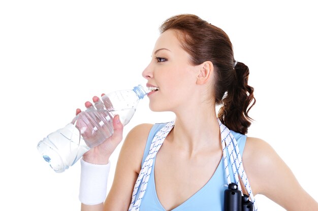 Free photo profile of young woman drinking water on white