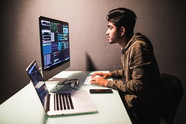 Free photo program development concept. young indian man working with computer