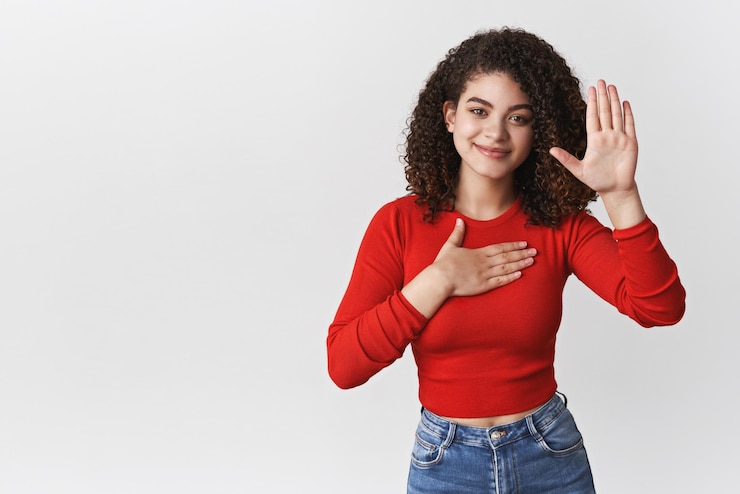Free Photo promise tell truth charming happy relaxed sincere young curlyhaired girl pleadging oath swear hold hand heart raise palm making statement smiling happily standing white background copy space