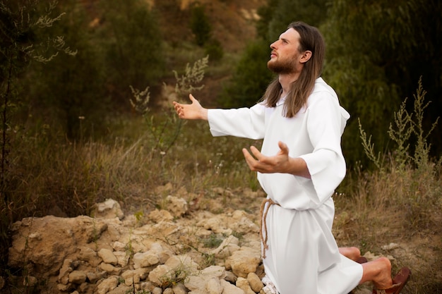 Free photo prophet praying outdoors full shot