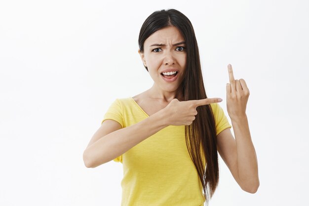 Proposal maybe. Pissed and confused attractive european female in yellow t-shirt frowning and arguing