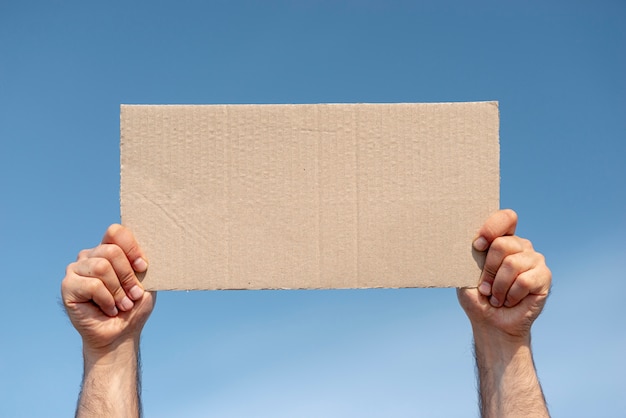 Protester holding board with mock-up