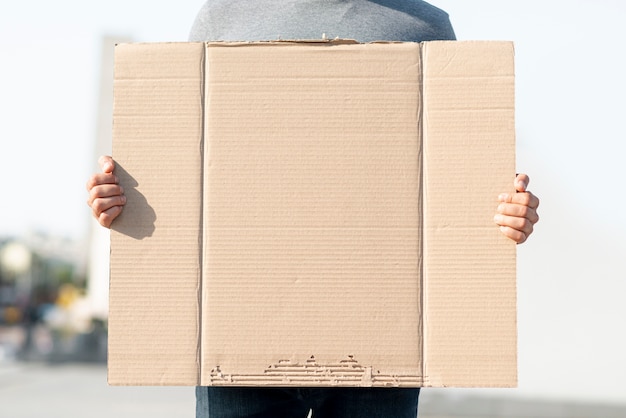 Protester holding cardboard with mock-up