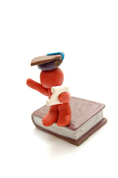 Proud plasticine figure with a graduation cap