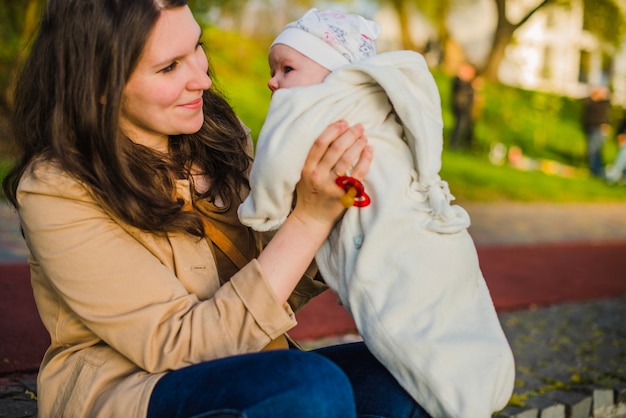 Free photo proud woman looking at her baby