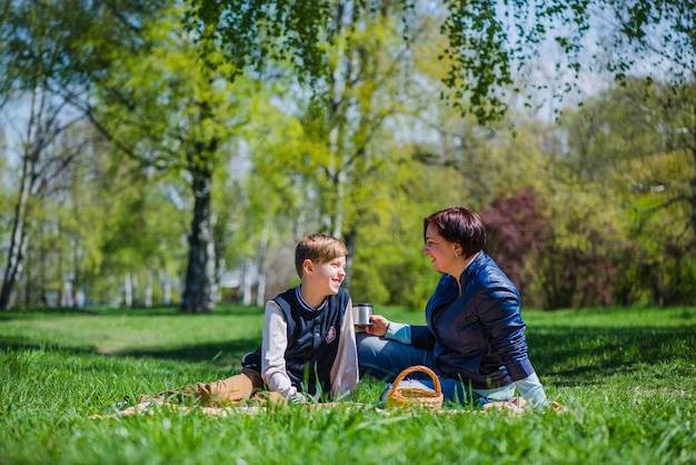 Proud woman with her son in the park