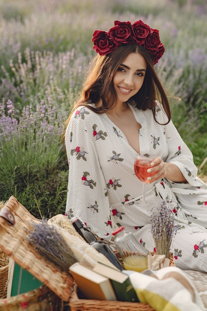 Provence woman relaxing in lavender field. lady in a picnic. woman in a wreath of flowers.