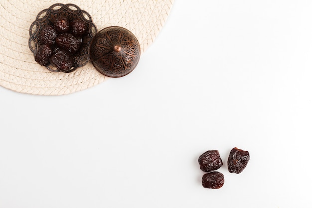 Prunes on saucer against mat