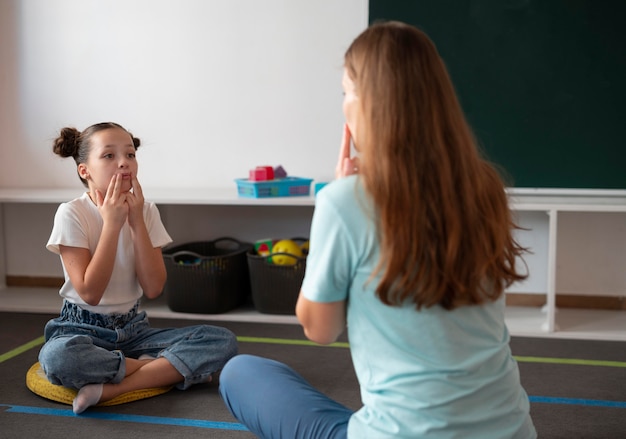 Free photo psychologist helping a girl in speech therapy