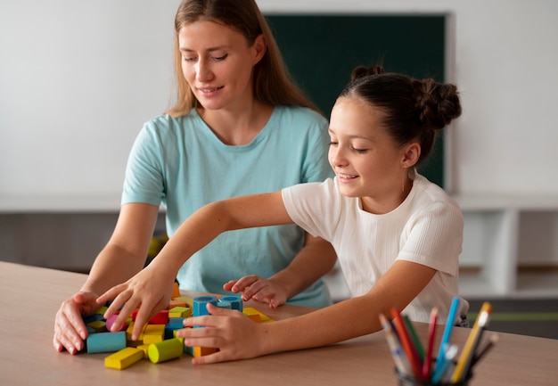 Psychologist helping a girl in speech therapy