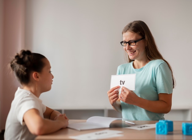 Psychologist helping a girl in speech therapy