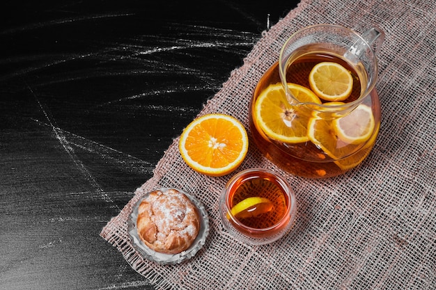 Free photo puff pastry bun with lemonade on black.