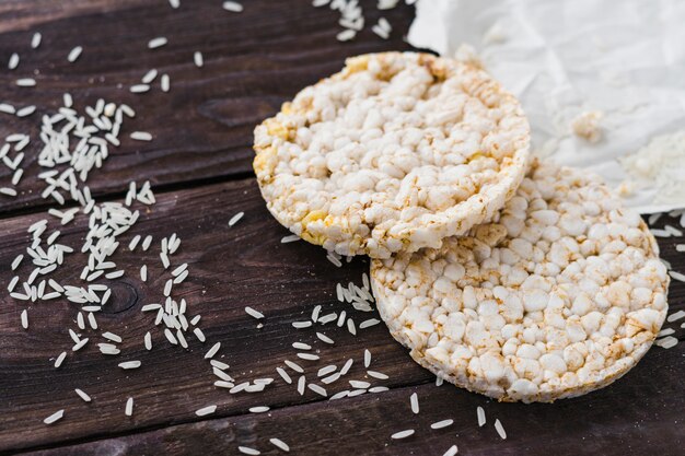 Puffed rice cake and grains on wooden table