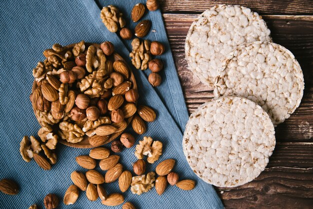 Puffed rice and nuts layout on wooden background