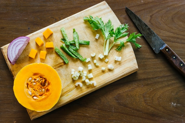 Pumpkin; celery and onion on chopping board