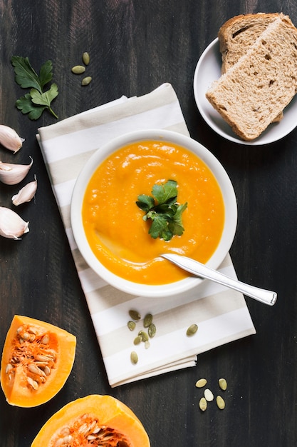 Pumpkin cream soup with bread top view