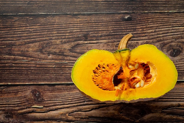 Pumpkin cut in half put on wooden floor