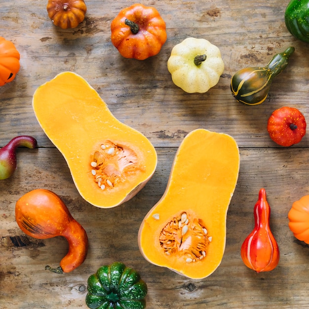 Pumpkin cut in half surrounded by vegetables