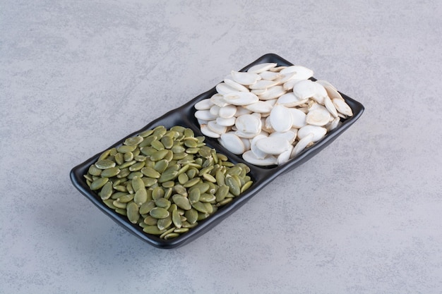 Pumpkin seeds isolated on concrete surface.