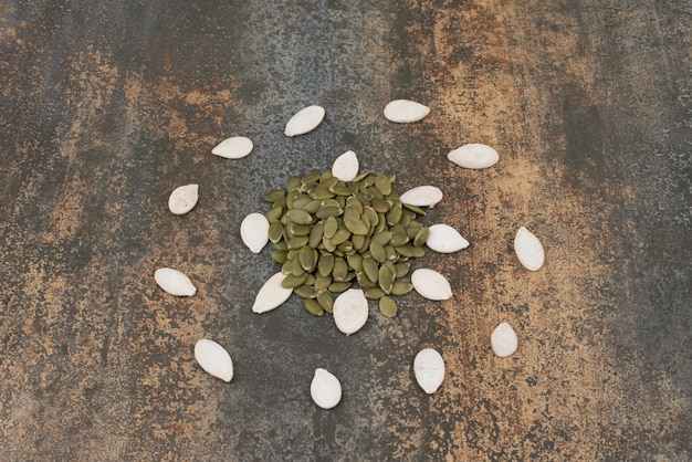 Free photo pumpkin seeds on marble surface .