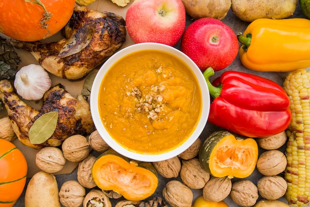 Pumpkin soup in bowl on food background