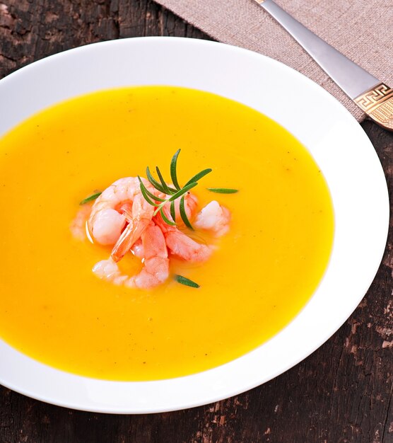 Pumpkin soup with shrimp and rosemary