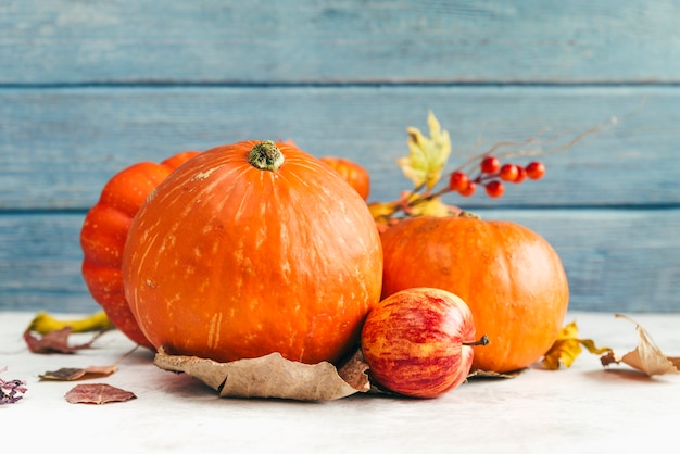 Pumpkins and apple on table