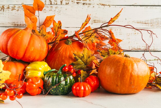 Pumpkins among colorful autumn leaves