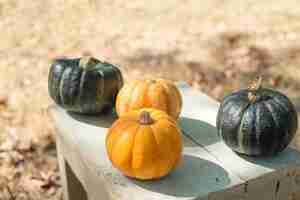 Free photo pumpkins on wooden table outdoors