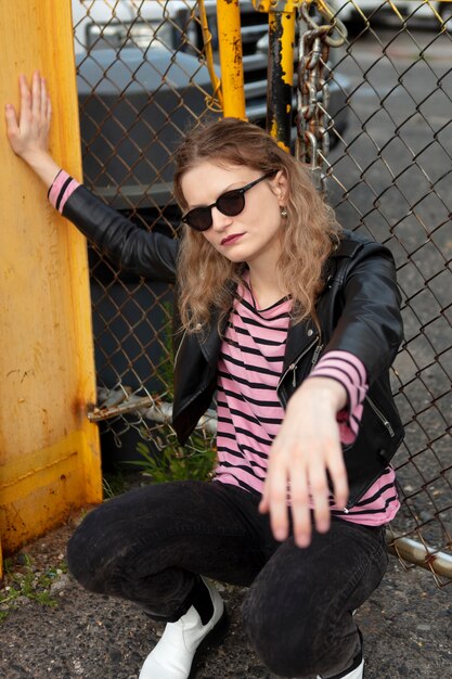 Punk female with sunglasses in urban location