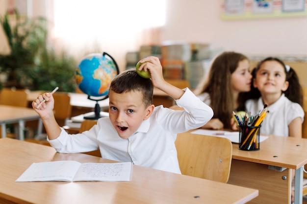 Pupil having fun with apple