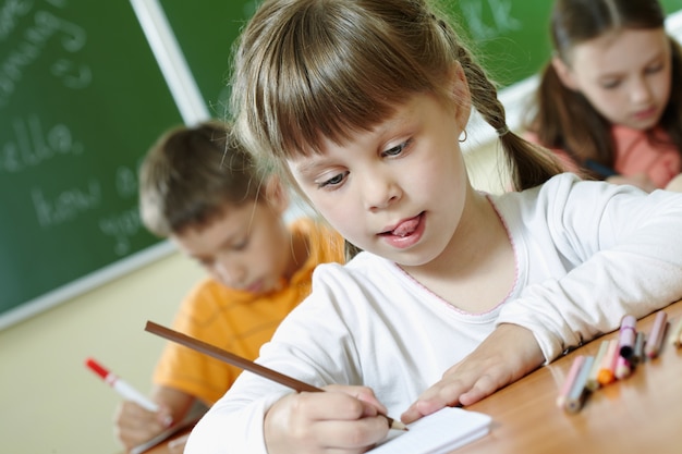 Pupil holding a crayon