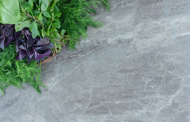 Purple basil and with parsley , on the marble table. 
