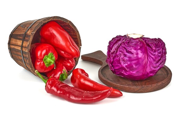 Purple cabbage on a wooden platter and chilies out of a bucket.