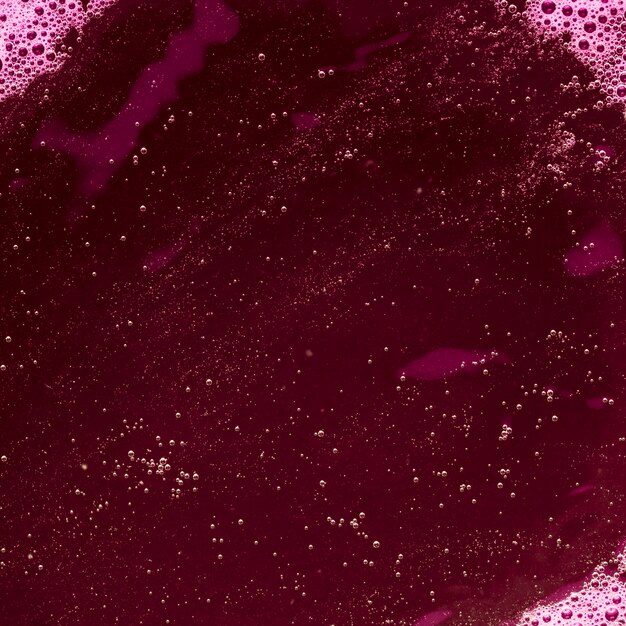 Purple colored liquid with bubbles