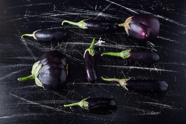 Purple eggplants on black