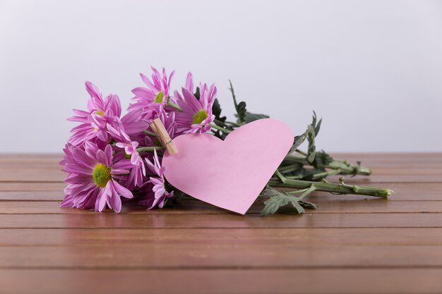 Purple flowers and cut out heart
