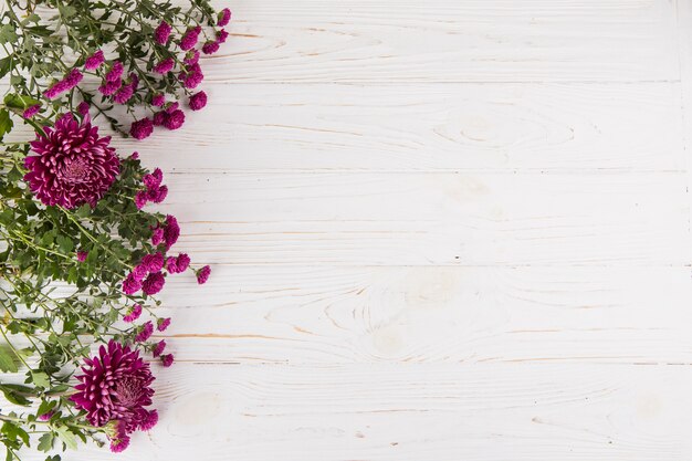 Purple flowers scattered on wooden table