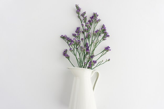 Purple flowers on white vase