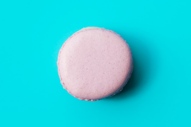 Purple macaroon on blue background