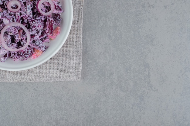 Purple onion salad in a white ceramic plate