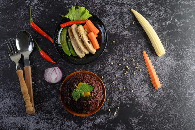 Purple rice berries cooked with grilled chicken breast. Pumpkin, carrots, and mint leaves in a dish, clean food.