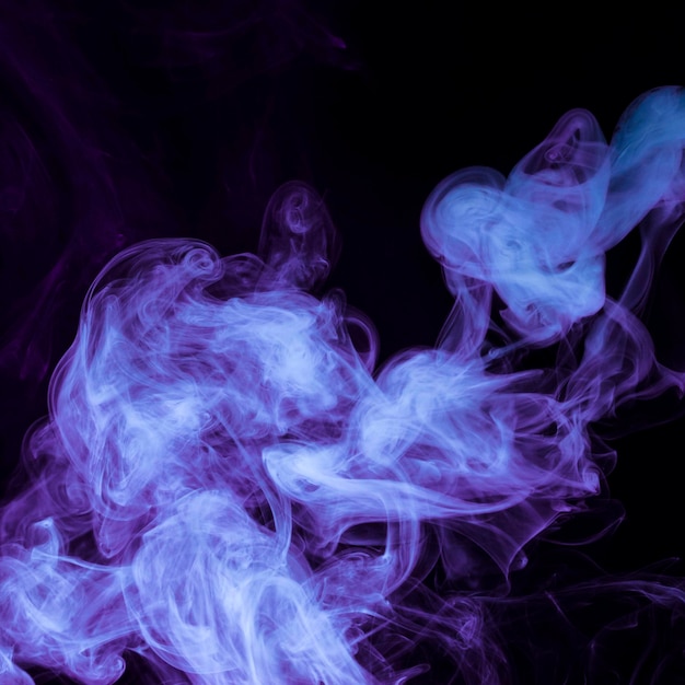 Purple smoke spread on the black background